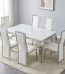 White marble dining set featuring a rectangular white faux-marble tabletop with a polished silver stainless steel frame and apron trim, six matching high-back dining chairs with white faux leather upholstery, and polished silver stainless steel curved cabriole legs.