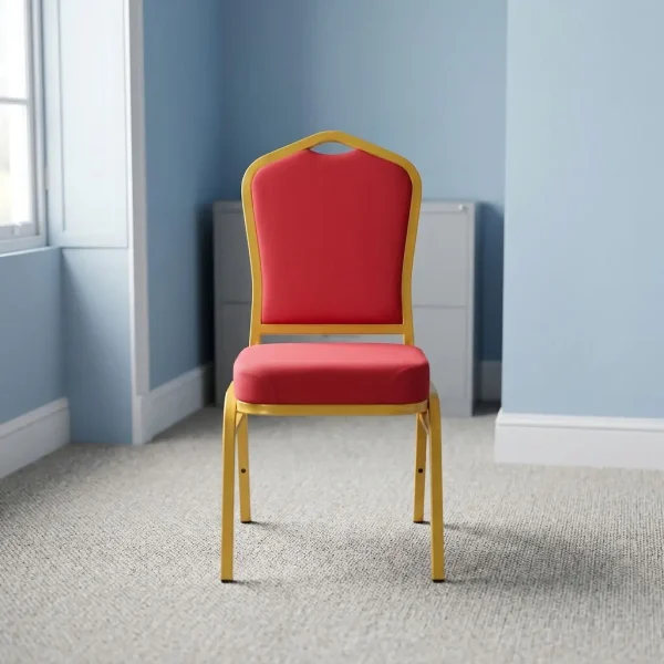 High quality red banquet chair featuring a crown-back profile with red fabric upholstered backrest and a high-density cushioned seat pan, a stackable armless frame design with protective stacking bumpers, and a gold powder-coated square steel tube four-leg base with non-marring floor glides.