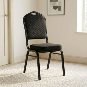 Stackable black fabric event chair featuring diamond-quilted black fabric upholstery with subtle flecked pattern details, a high-density padded crown-back backrest with integrated top handhold cut-out and thick cushioned seat, armless space-saving configuration, stackable design with side frame bumpers, and a heavy-duty black powder-coated tubular steel four-legged frame equipped with protective floor glides. Stackable black fabric event chair featuring diamond-quilted black fabric upholstery with subtle flecked pattern details, a high-density padded crown-back backrest with integrated top handhold cut-out and thick cushioned seat, armless space-saving configuration, stackable design with side frame bumpers, and a heavy-duty black powder-coated tubular steel four-legged frame equipped with protective floor glides.