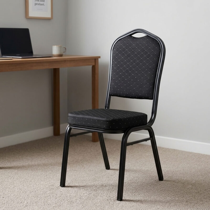 Stackable black fabric event chair featuring diamond-quilted black fabric upholstery with subtle flecked pattern details, a high-density padded crown-back backrest with integrated top handhold cut-out and thick cushioned seat, armless space-saving configuration, stackable design with side frame bumpers, and a heavy-duty black powder-coated tubular steel four-legged frame equipped with protective floor glides. Stackable black fabric event chair featuring diamond-quilted black fabric upholstery with subtle flecked pattern details, a high-density padded crown-back backrest with integrated top handhold cut-out and thick cushioned seat, armless space-saving configuration, stackable design with side frame bumpers, and a heavy-duty black powder-coated tubular steel four-legged frame equipped with protective floor glides.