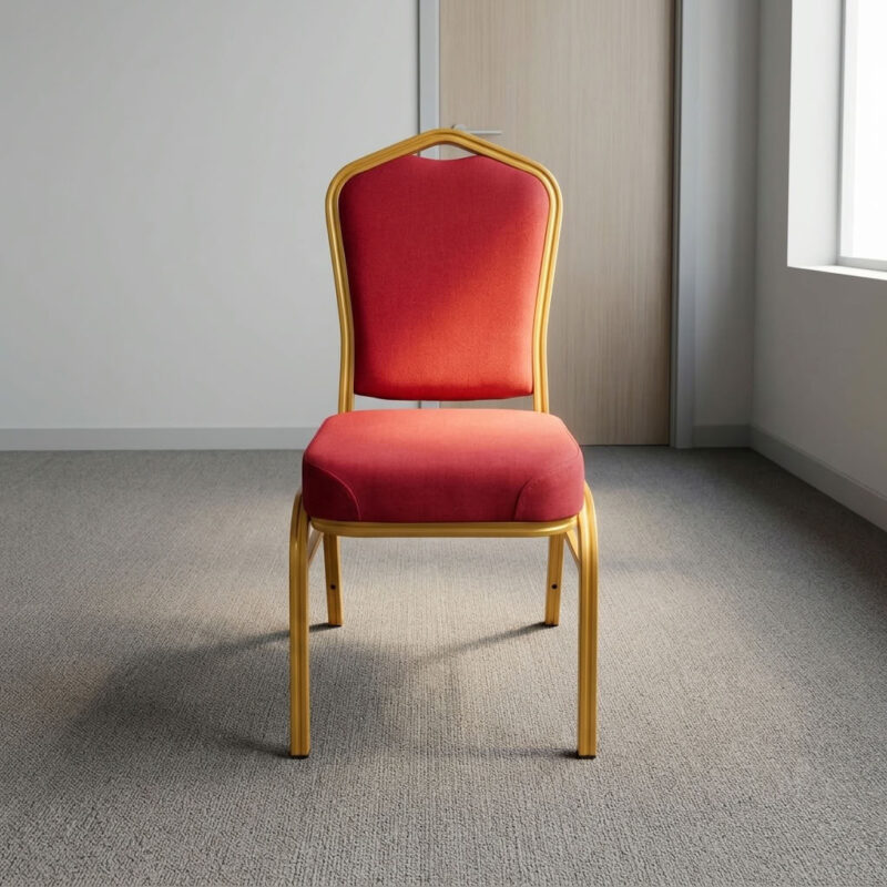 Red fabric stackable event chair featuring rich crimson red fabric upholstery, a high-density padded crown-back backrest with integrated top handhold cut-out and thick cushioned seat, armless space-saving stackable design with frame bumper guards, and a heavy-duty metallic gold powder-coated tubular steel four-legged frame equipped with protective floor glides. Red fabric stackable event chair featuring rich crimson red fabric upholstery, a high-density padded crown-back backrest with integrated top handhold cut-out and thick cushioned seat, armless space-saving stackable design with frame bumper guards, and a heavy-duty metallic gold powder-coated tubular steel four-legged frame equipped with protective floor glides.