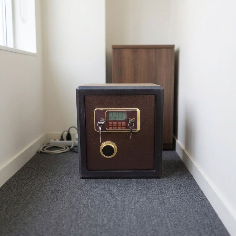 40kgs fireproof safebox featuring a heavy-duty dark brown and black powder-coated alloy steel body, a gold-trimmed electronic digital keypad with an LCD display screen, dual-key override locking mechanisms with a rotary turn knob, motorized live-locking bolts for high-security storage, and a solid flat base with floor-protective glides.